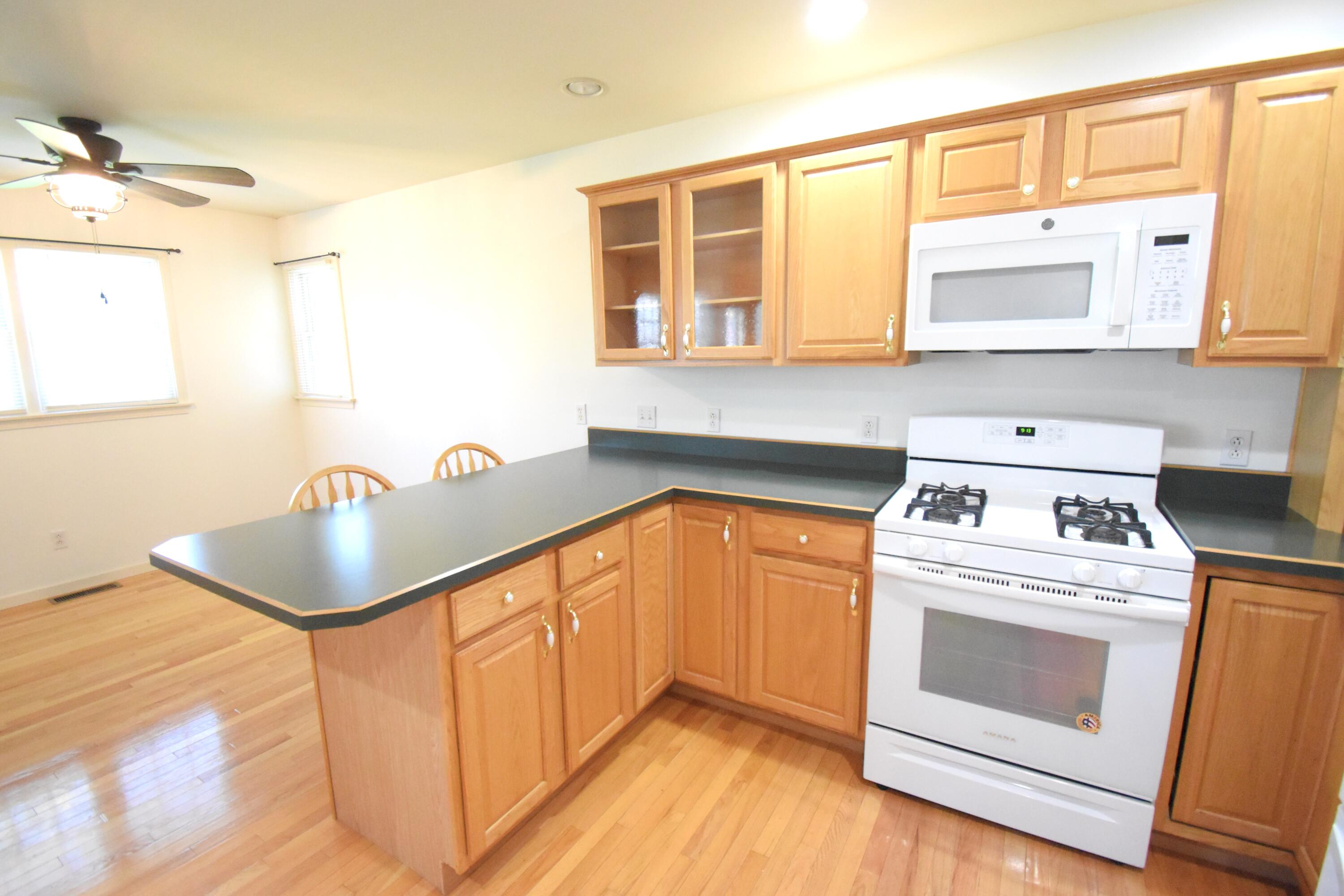 522 Pheasant Run Rensselaer, IN 47978 - Photo 30 of 55 a kitchen with granite countertop a sink a stove and cabinets