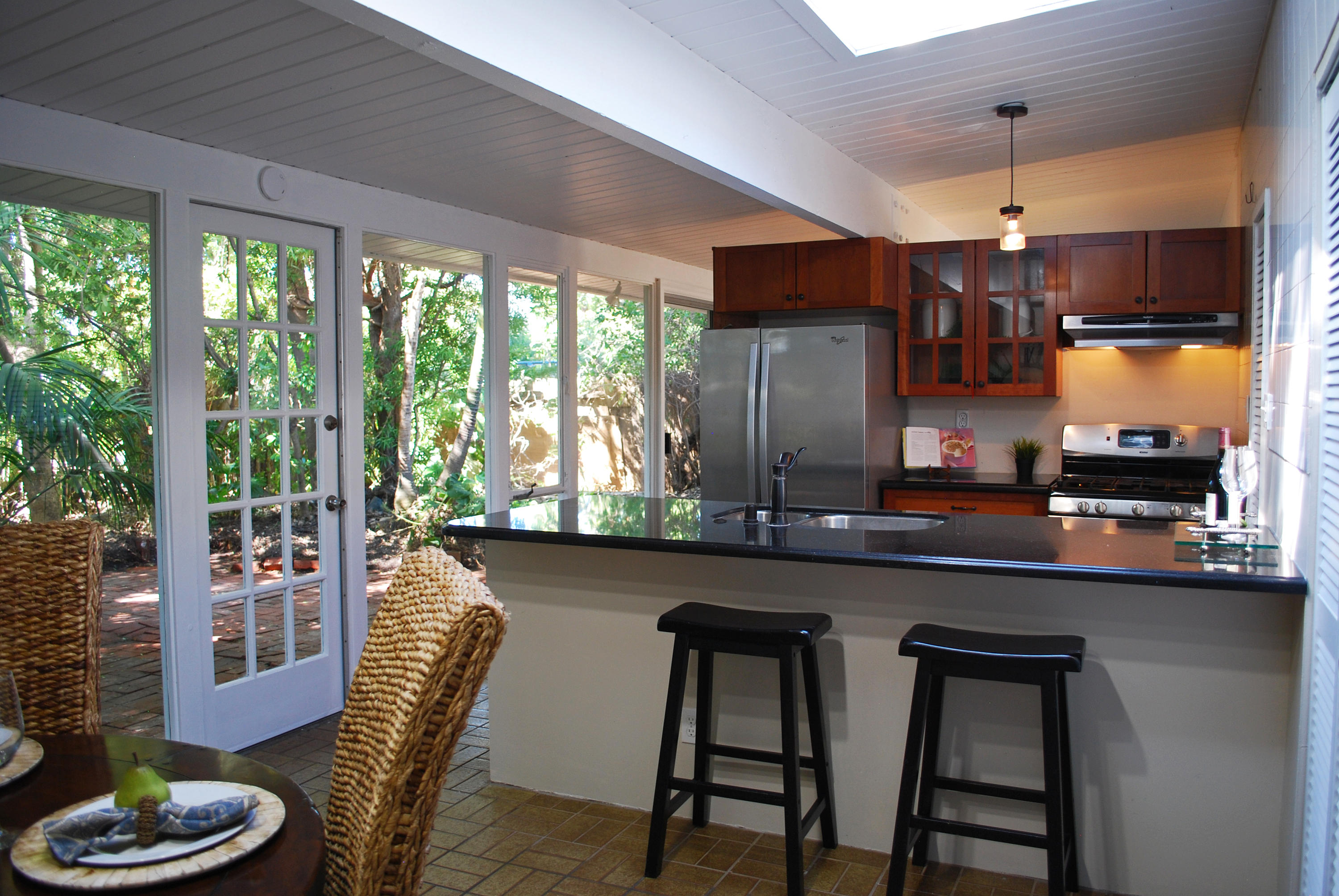 83 Cardinal Avenue Goleta, CA 93117 - Photo 7 of 17 a kitchen with stainless steel appliances granite countertop a sink and a chairs