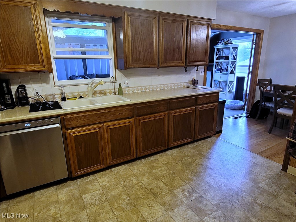2768 Greenridge Road Barberton, OH 44203 - Photo 5 of 14 Kitchen featuring decorative backsplash, dishwasher, light hardwood / wood-style flooring, and sink