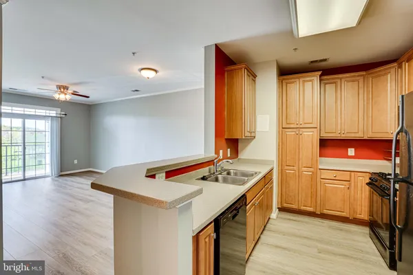 a kitchen with kitchen island a sink appliances and cabinets