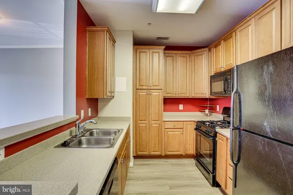 a room with a sink cabinets and wooden floor