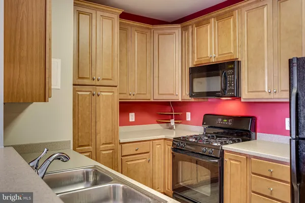 a kitchen with a refrigerator sink and stove