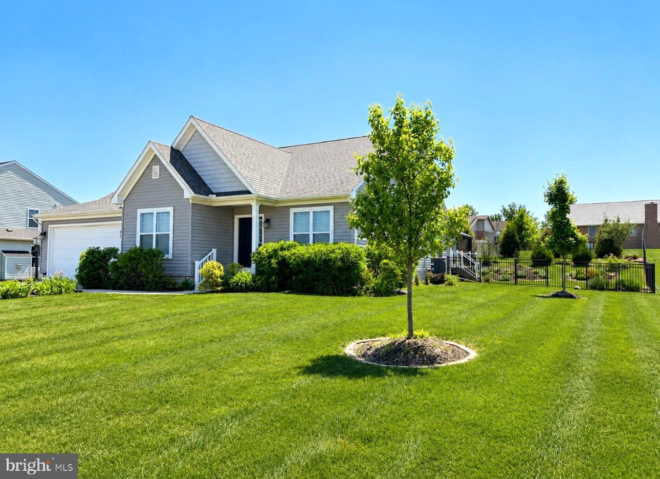 2309 Palomino Road Dover, PA 17315 - Photo 3 of 7 a house with a garden and trees