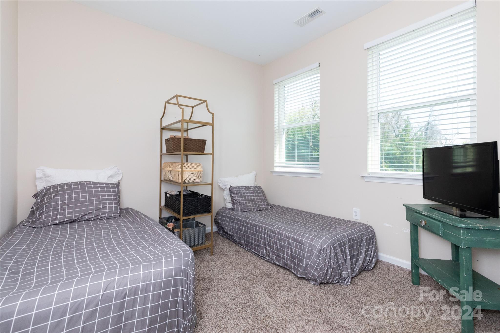 72 Shiloh Road Asheville, NC 28803 - Photo 12 of 15 a bedroom with a bed and a flat tv screen on a dresser