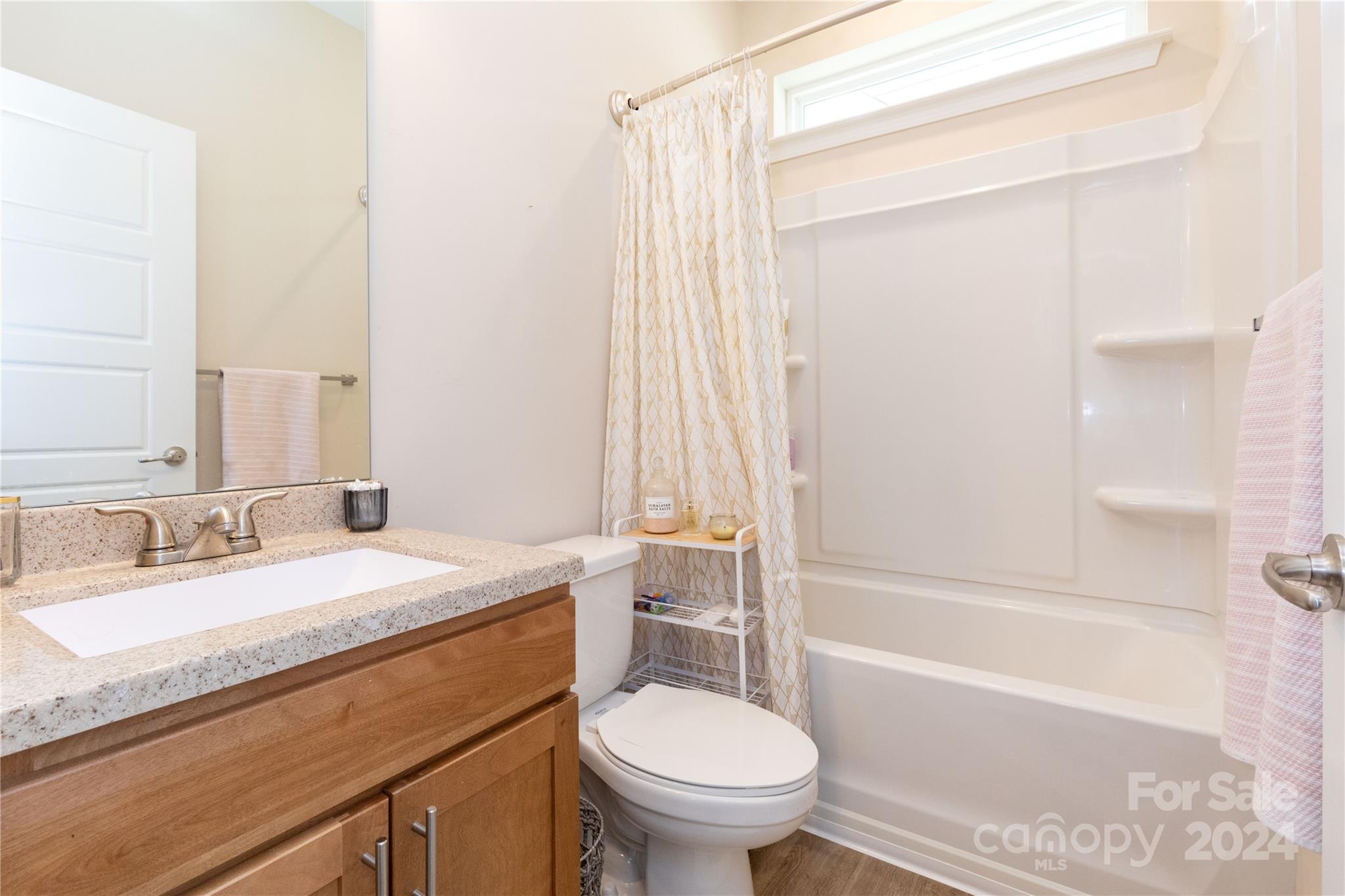 72 Shiloh Road Asheville, NC 28803 - Photo 13 of 15 a bathroom with a granite countertop sink toilet and shower