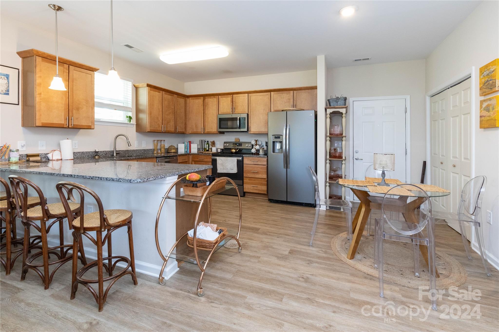 72 Shiloh Road Asheville, NC 28803 - Photo 5 of 15 a kitchen with stainless steel appliances granite countertop dining table chairs cabinets and a window