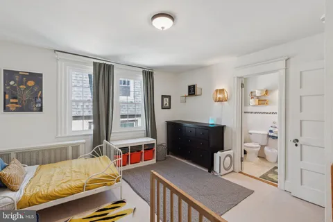 a bedroom with furniture and a window