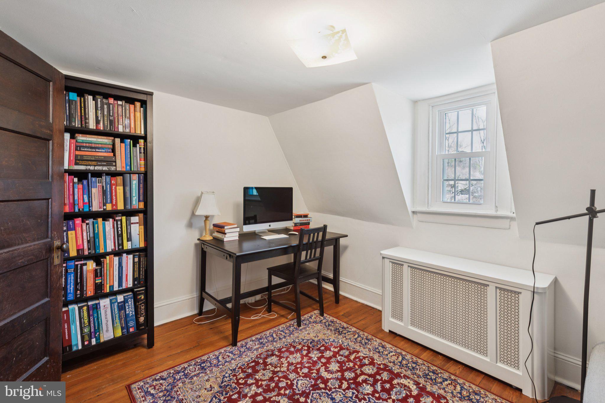 519 Burnham Road Philadelphia, PA 19119 - Photo 24 of 56 a view of a workspace with bookshelf and a window