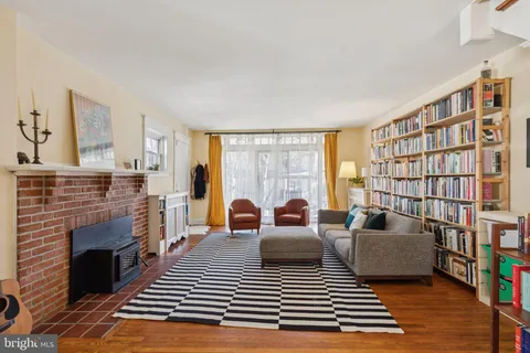 a living room with furniture a rug and a fireplace