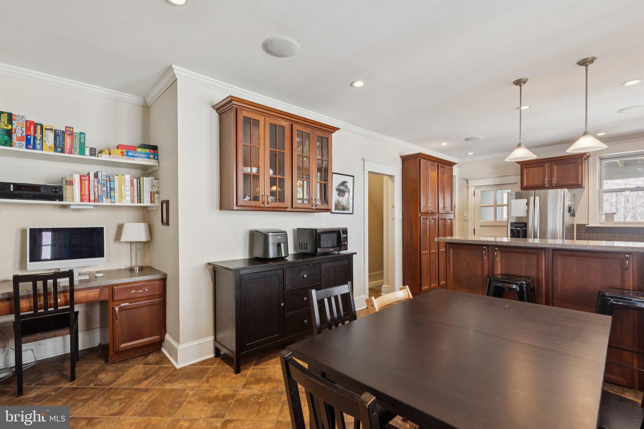 519 Burnham Road Philadelphia, PA 19119 - Photo 28 of 56 a kitchen with stainless steel appliances a stove a refrigerator a sink a dining table and chairs