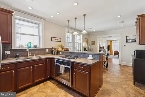 a kitchen with a stove sink and cabinets