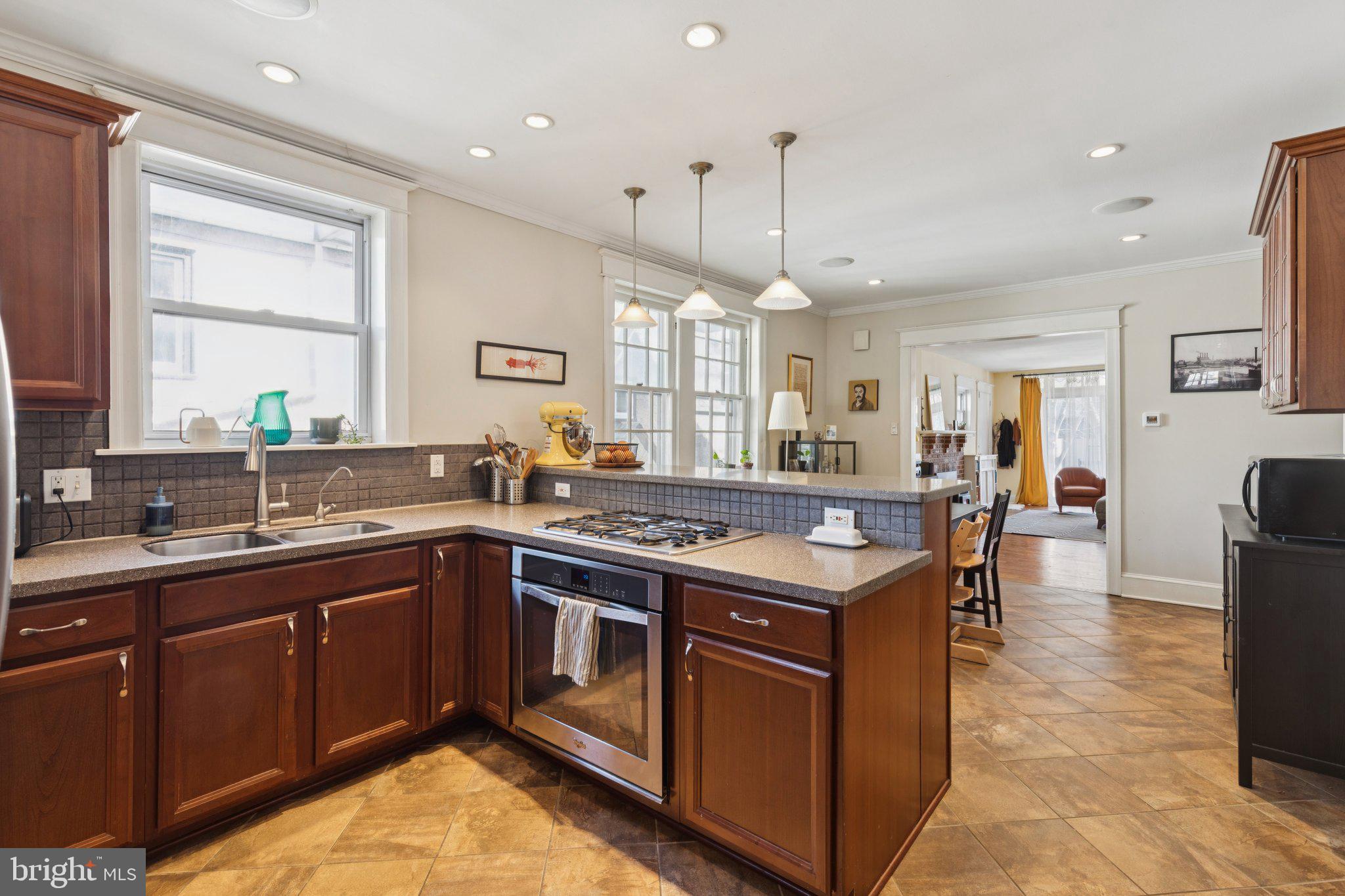 519 Burnham Road Philadelphia, PA 19119 - Photo 32 of 56 a kitchen with a stove sink and cabinets