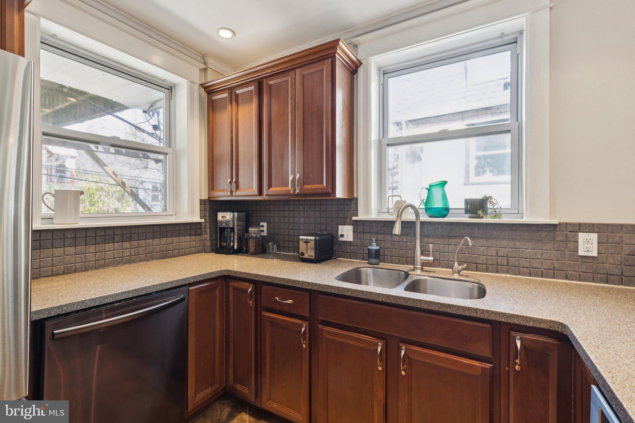519 Burnham Road Philadelphia, PA 19119 - Photo 34 of 56 a kitchen with a sink a window and cabinets