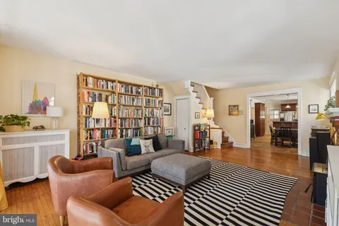 a living room with furniture a couch and next to a window