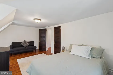 a bedroom with a bed and dresser