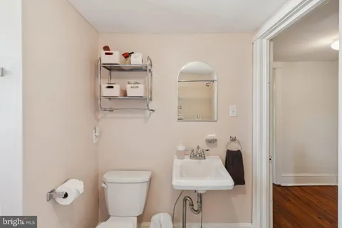 a bathroom with a toilet sink and mirror