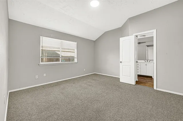 an empty room with closet and windows