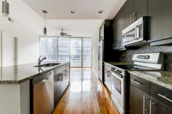a kitchen with stainless steel appliances granite countertop a stove and a sink
