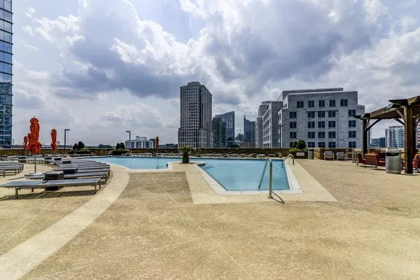 a view of swimming pool with outdoor seating and city view