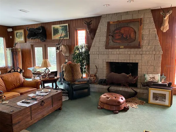 a living room with furniture and a floor to ceiling window