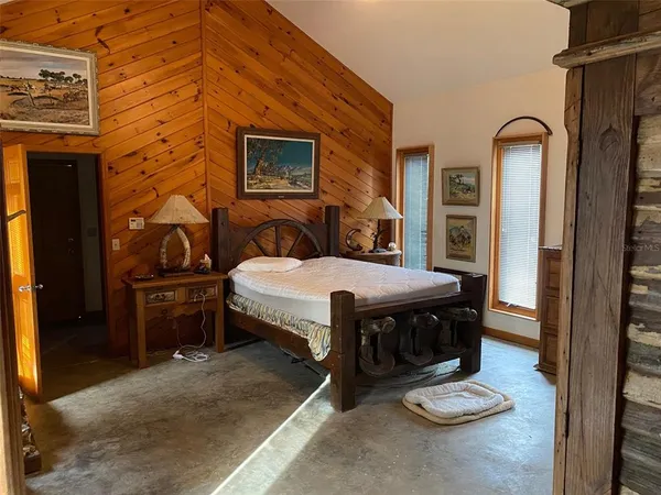 a view of swimming pool with trees and wooden fence
