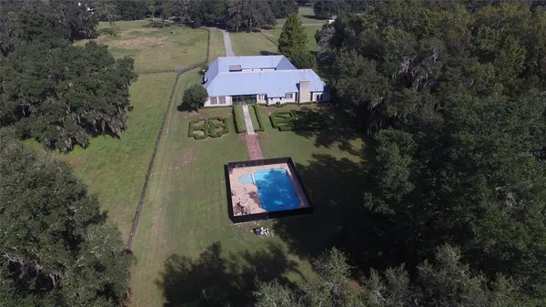 an aerial view of residential house with outdoor space and parking