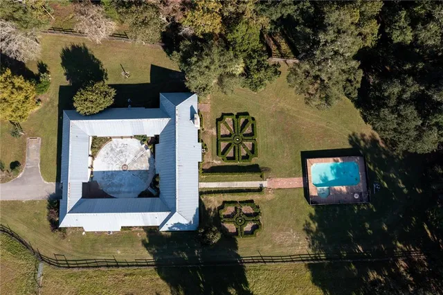 an aerial view of a house with a yard