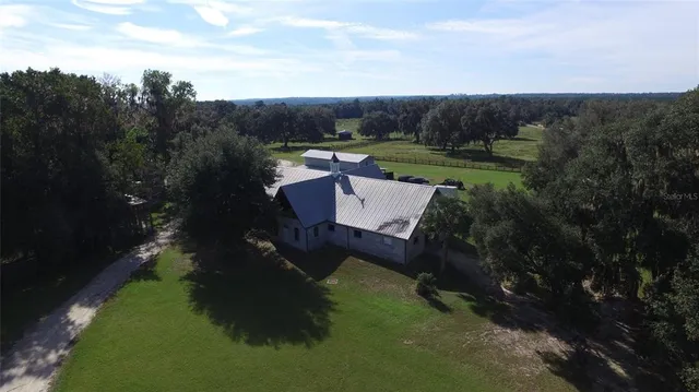 an aerial view of a house with a yard