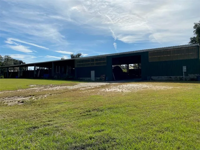 a aerial view of a house next to a yard