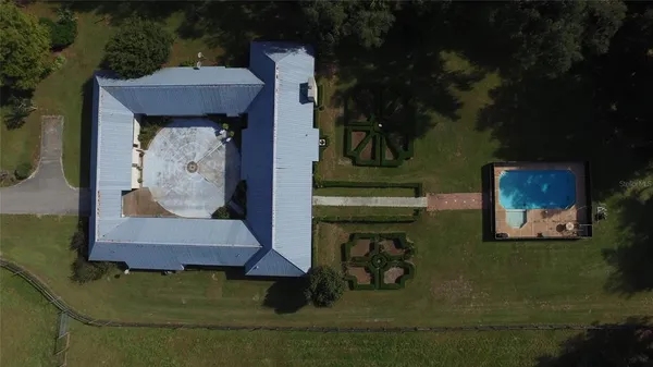 a kitchen with stainless steel appliances granite countertop a stove top oven a sink a dining table and chairs