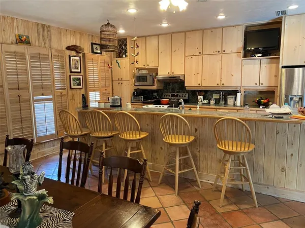 a living room with furniture fireplace and large windows