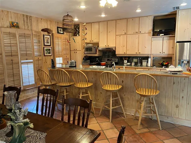 a living room with furniture fireplace and large windows
