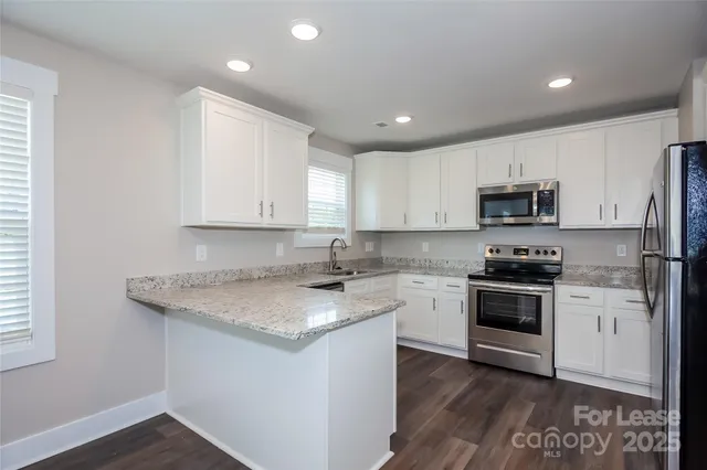 a kitchen with a sink stove and microwave