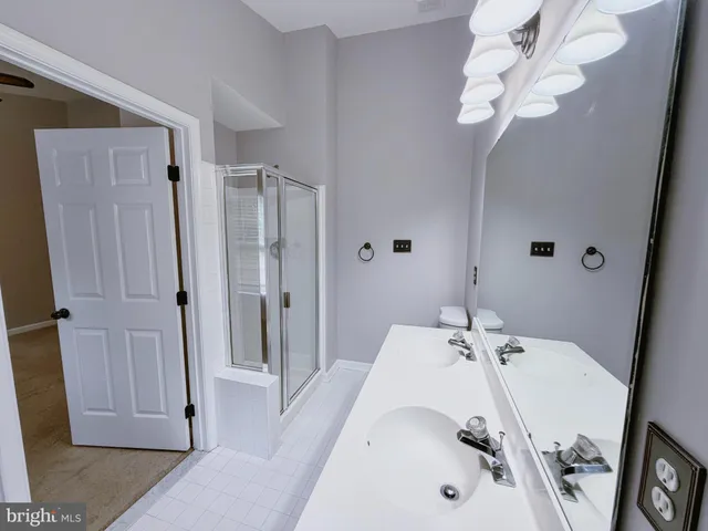 a bathroom with a tub sink and shower curtain