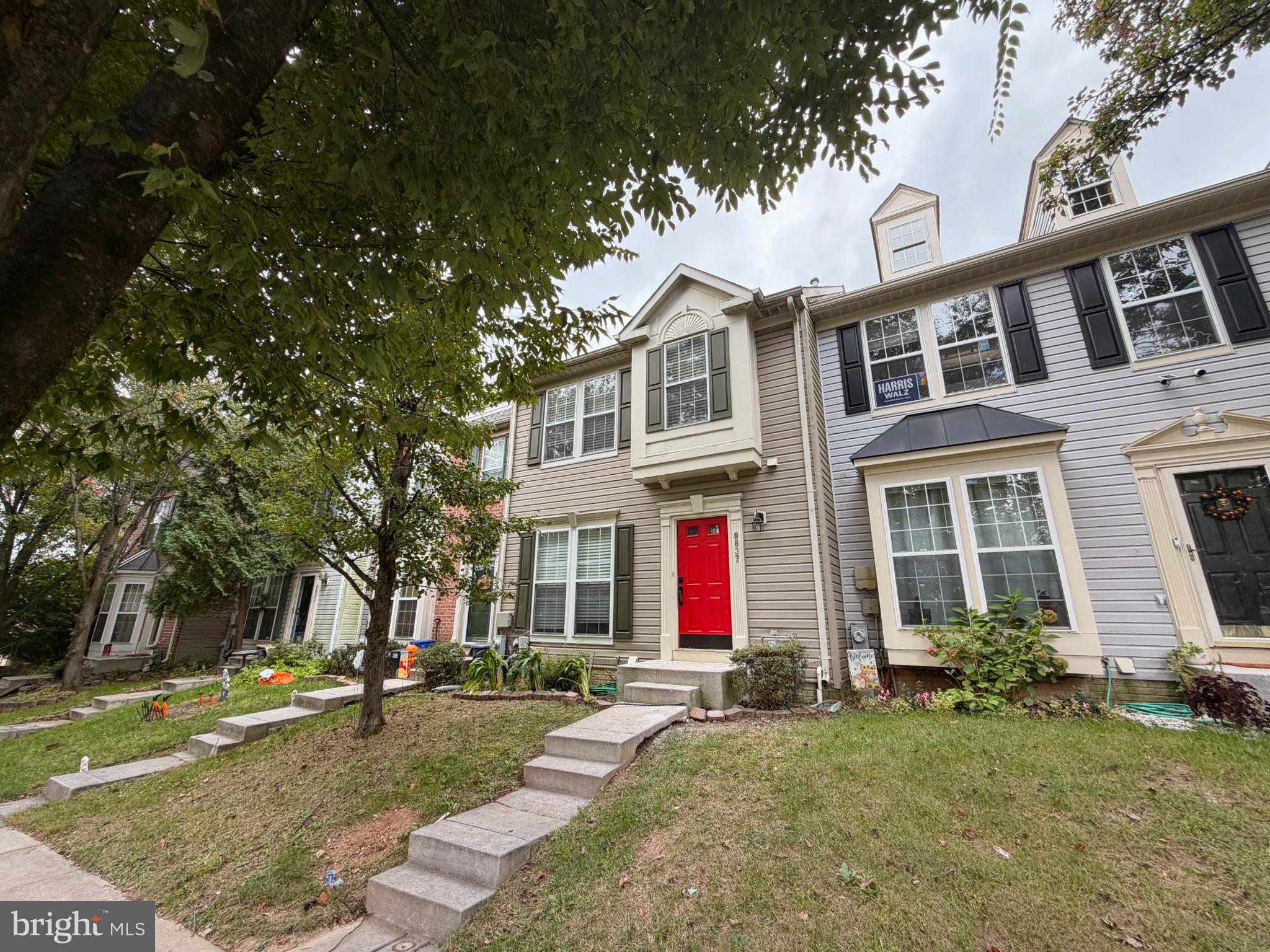 9837 Sherwood Farm Road Owings Mills, MD 21117 - Photo 2 of 27 a front view of a house with garden and trees