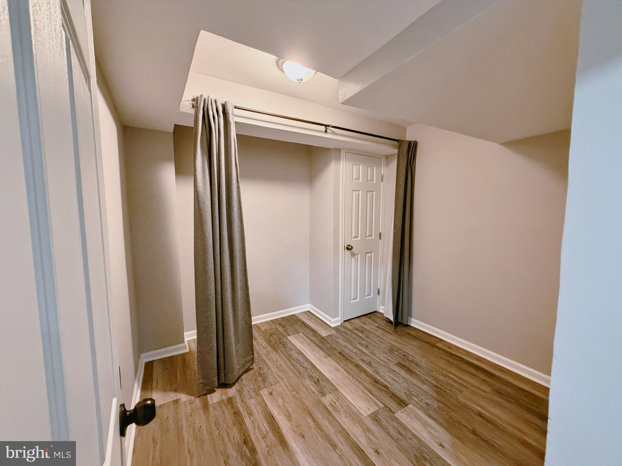 9837 Sherwood Farm Road Owings Mills, MD 21117 - Photo 25 of 27 a view of a hallway with wooden floor and closet