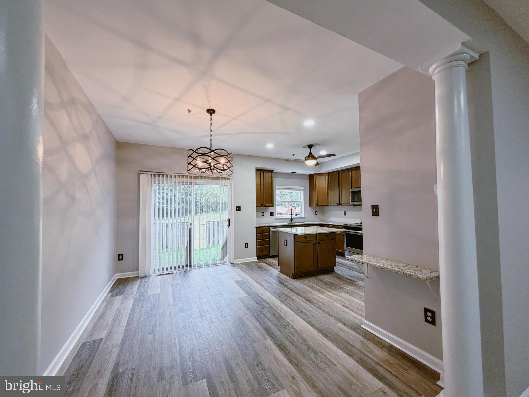 9837 Sherwood Farm Road Owings Mills, MD 21117 - Photo 5 of 27 an empty room with wooden floor and windows