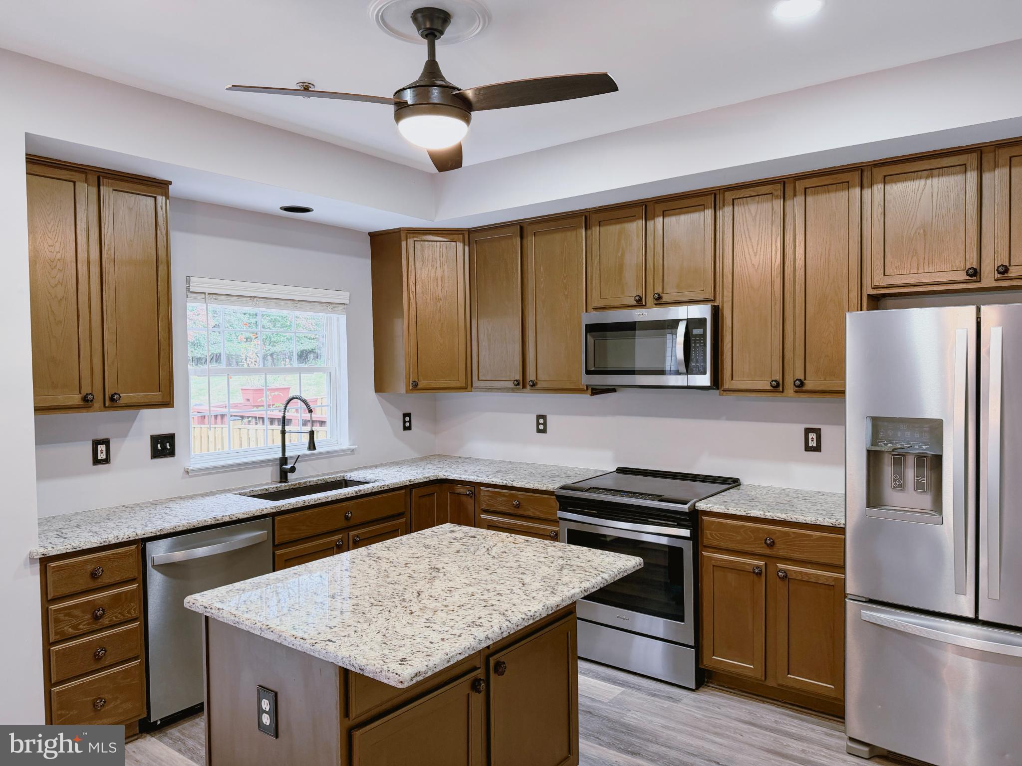 9837 Sherwood Farm Road Owings Mills, MD 21117 - Photo 8 of 27 a kitchen with a sink stove and microwave