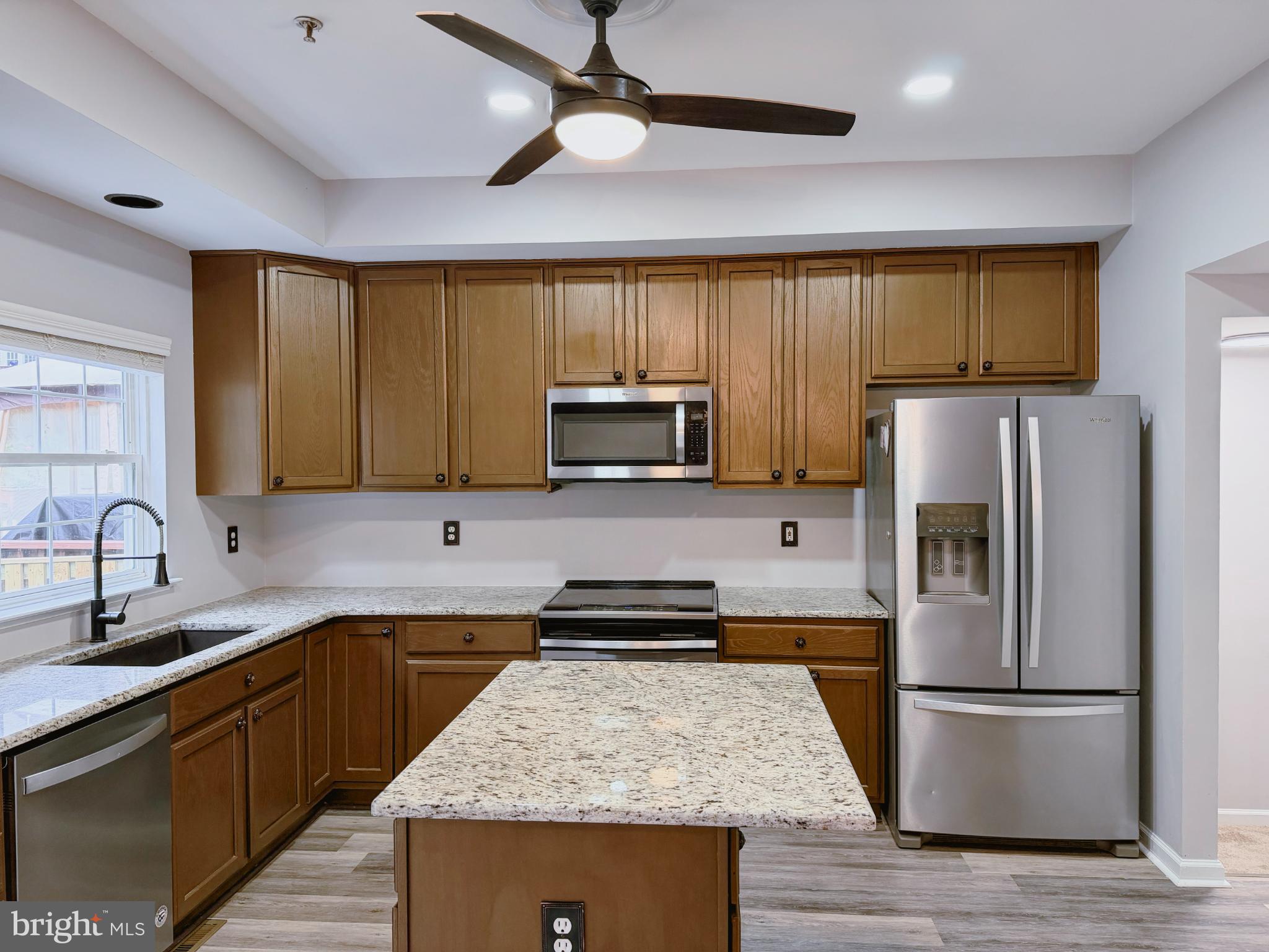 9837 Sherwood Farm Road Owings Mills, MD 21117 - Photo 9 of 27 a kitchen with wooden cabinets and stainless steel appliances