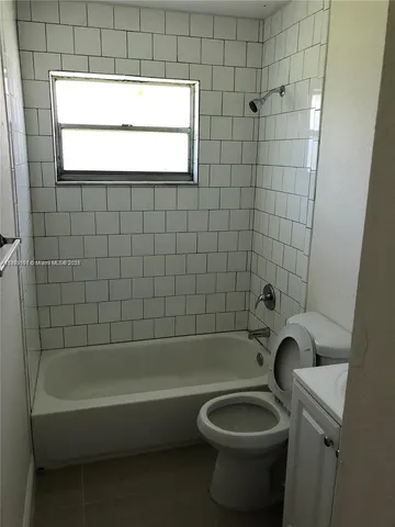 a bathroom with a toilet and a bathtub