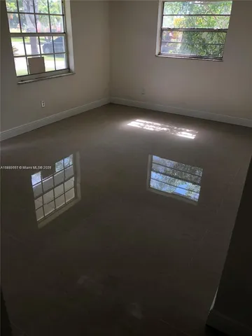 a view of an empty room with windows