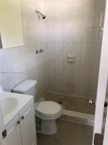 a bathroom with a toilet a sink and shower