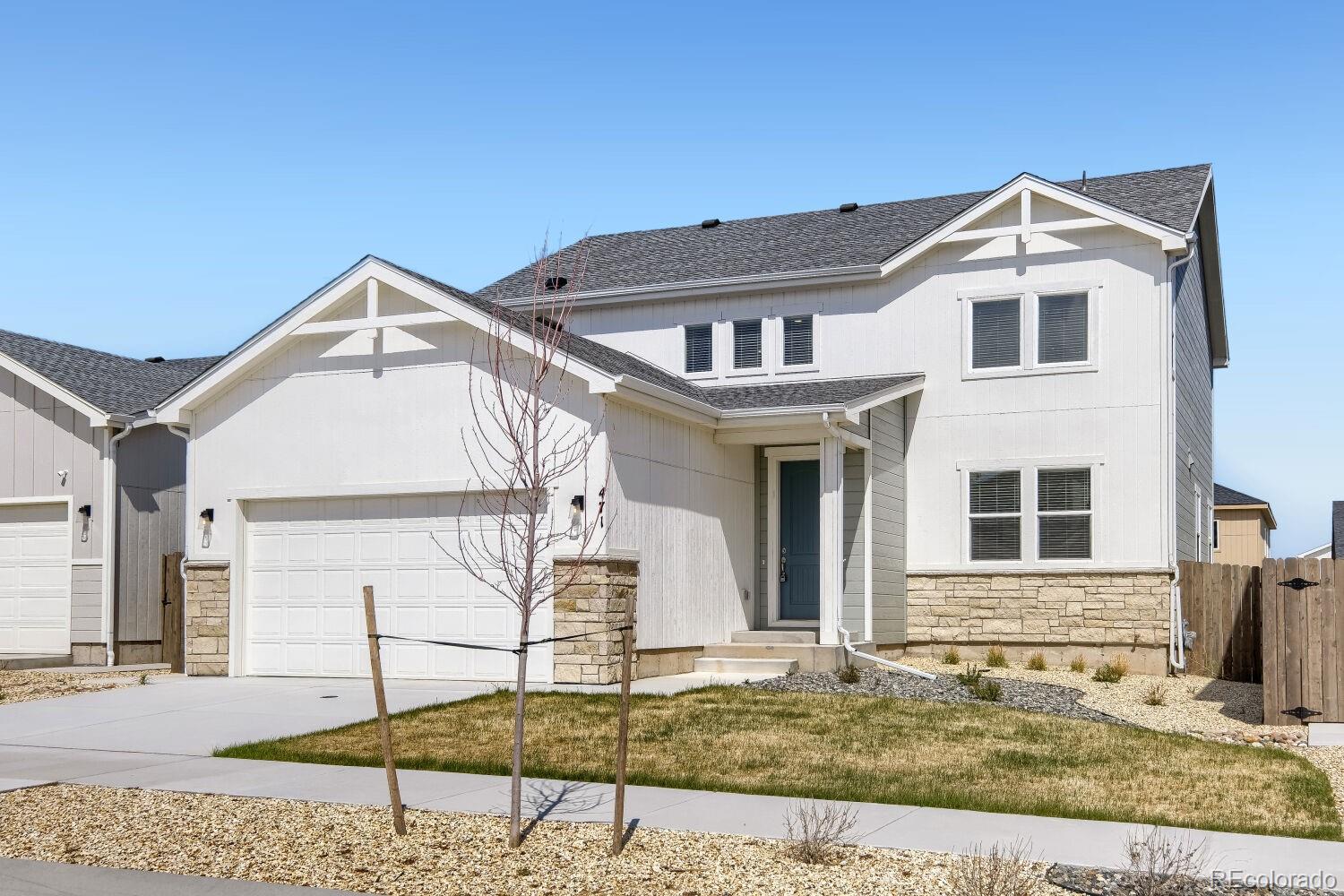 471 Atchison Way Calhan, CO 80808 - Photo 2 of 31 a view of a white house with a yard and table in front of it