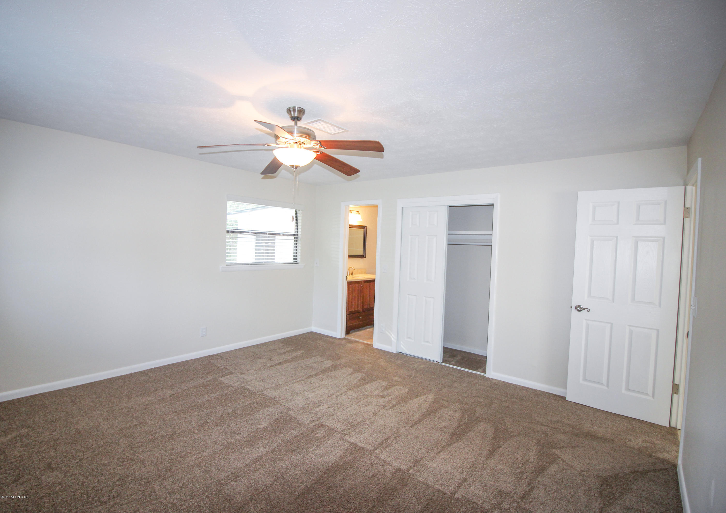 4134 Rogero Road Jacksonville, FL 32277 - Photo 11 of 36 a view of an empty room with a window