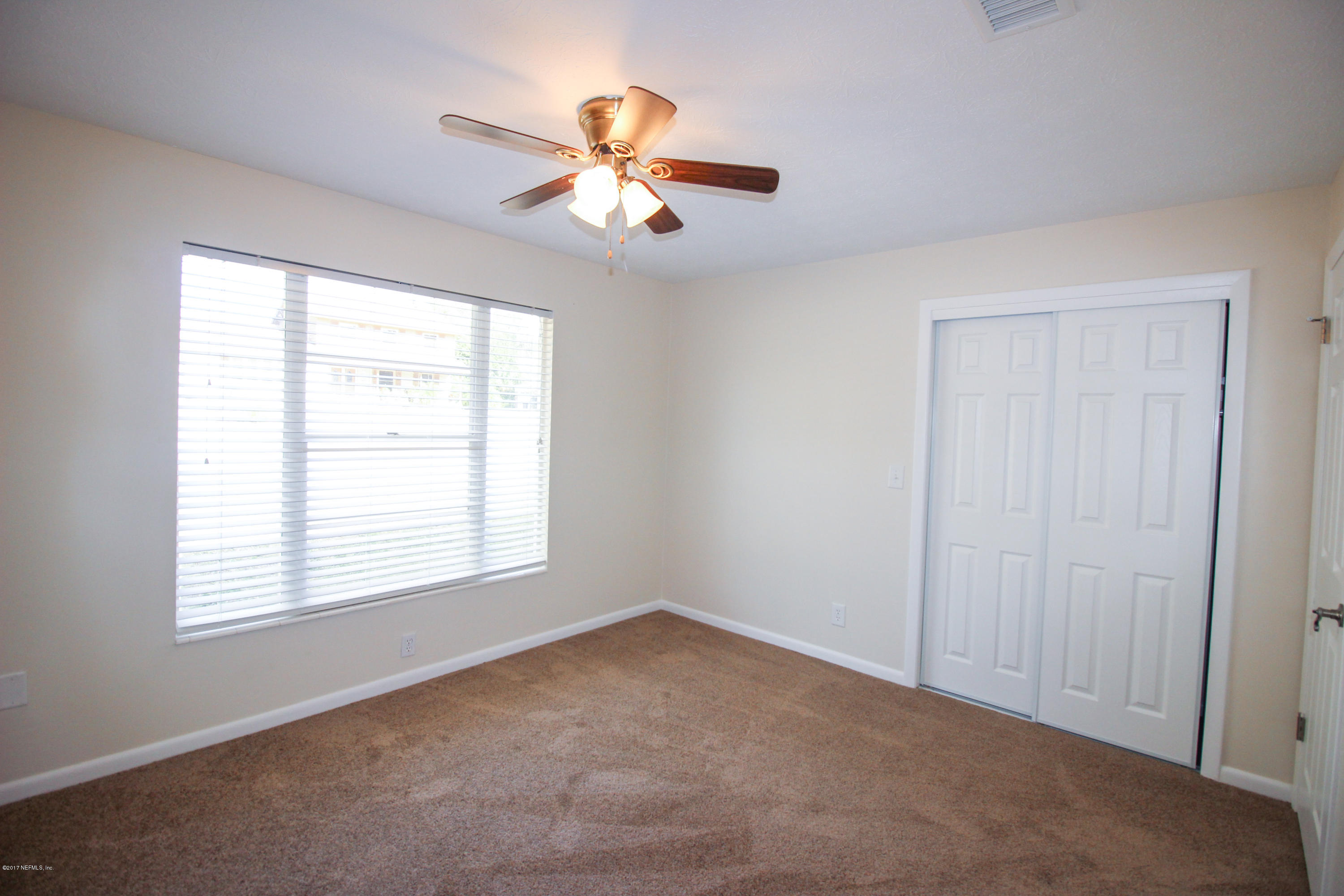 4134 Rogero Road Jacksonville, FL 32277 - Photo 13 of 36 a view of an empty room with a window