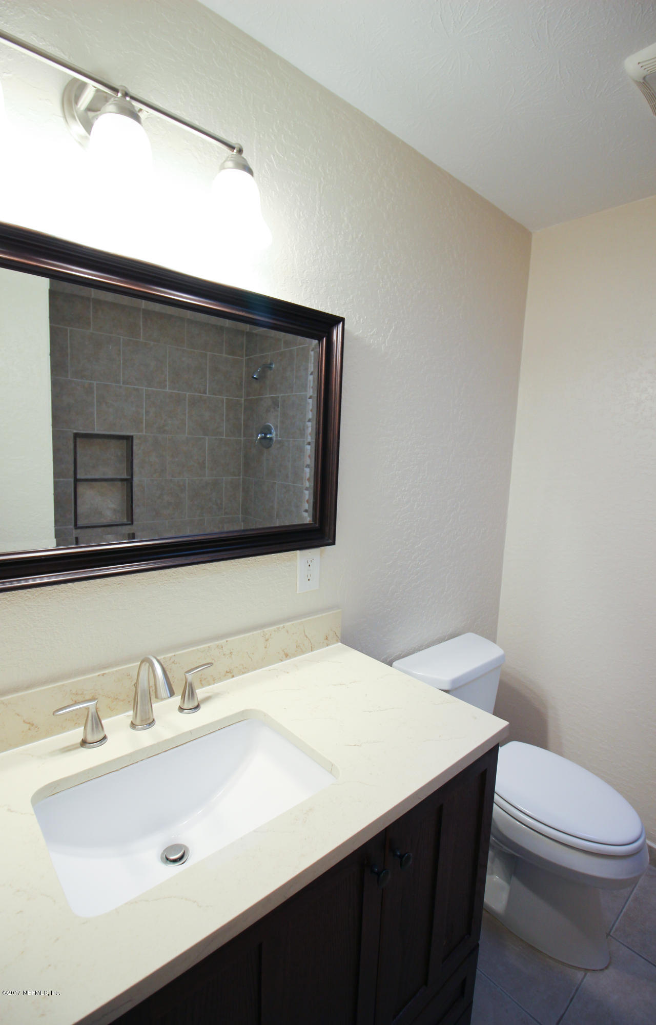 4134 Rogero Road Jacksonville, FL 32277 - Photo 17 of 36 a bathroom with a sink and a toilet