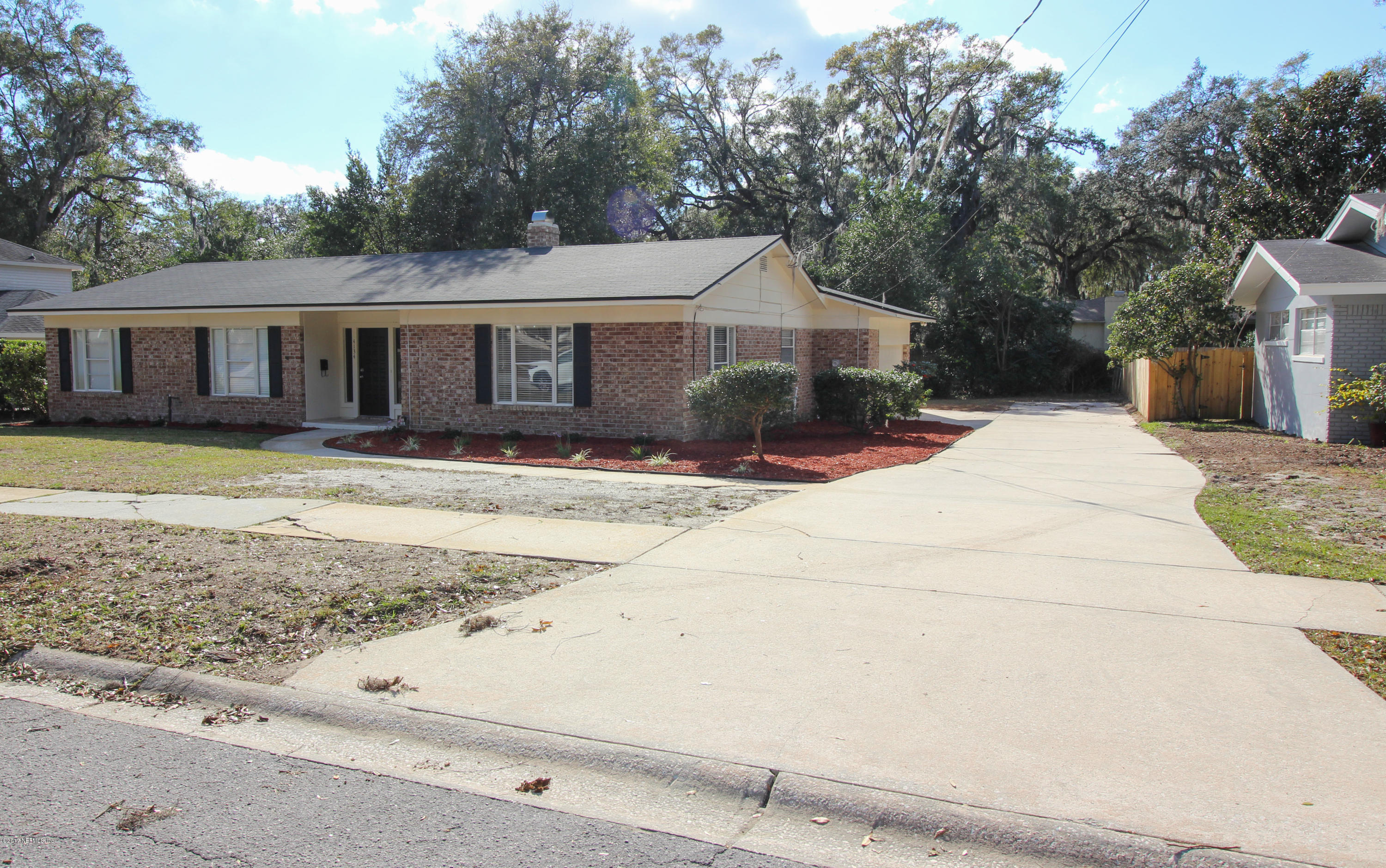 4134 Rogero Road Jacksonville, FL 32277 - Photo 25 of 36 a front view of a house with yard and seating area