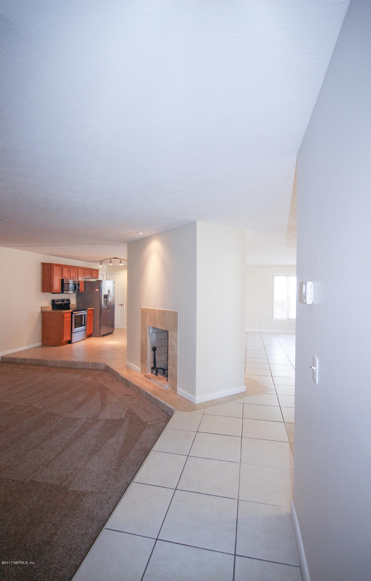 4134 Rogero Road Jacksonville, FL 32277 - Photo 36 of 36 a view of empty room with fireplace and window