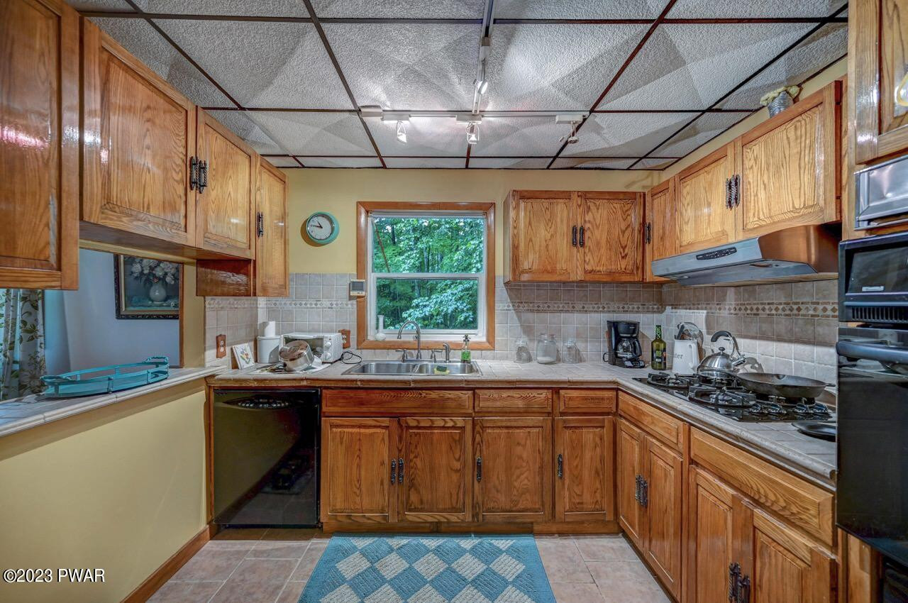 20 Wash Road Waymart, PA 18472 - Photo 13 of 49 a kitchen with a sink a stove a microwave and cabinets