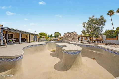 a view of house with yard and mountain view in front of it